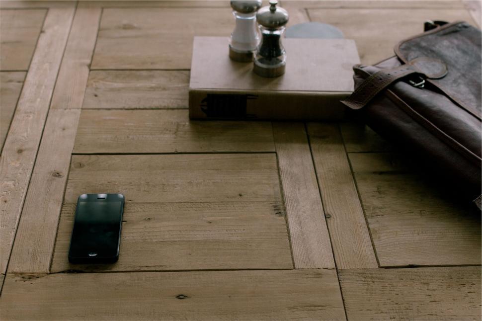 Free Image of Wooden desk with phone, book, salt and pepper shakers 