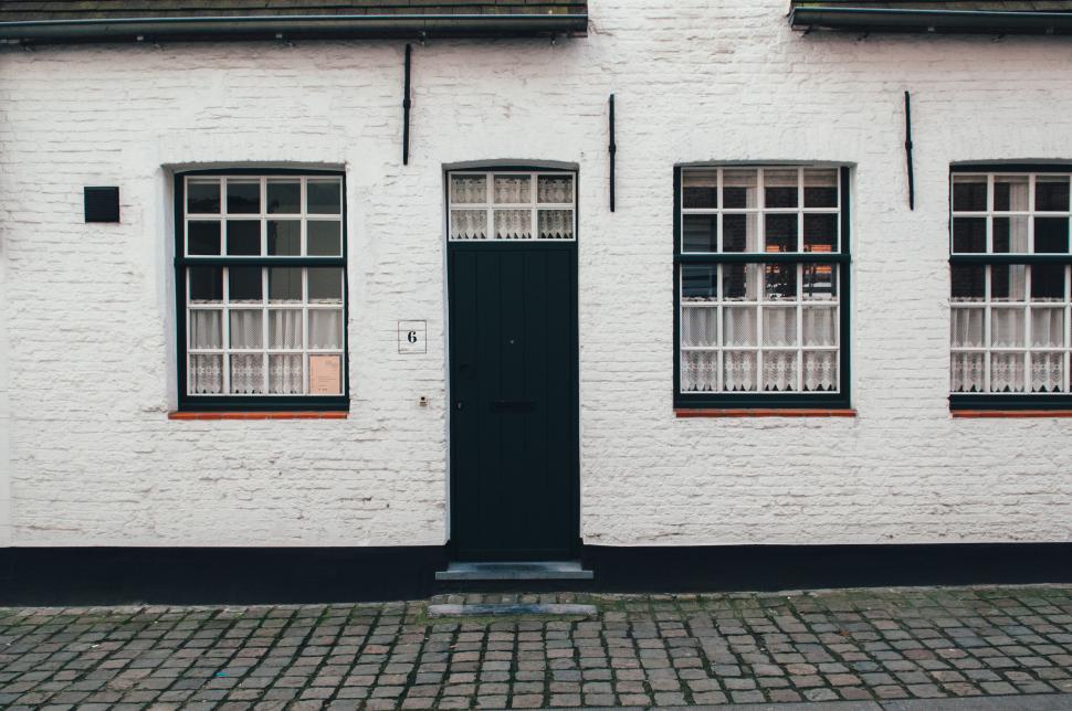 Free Image of Classic white brick exterior of a charming house facade. 