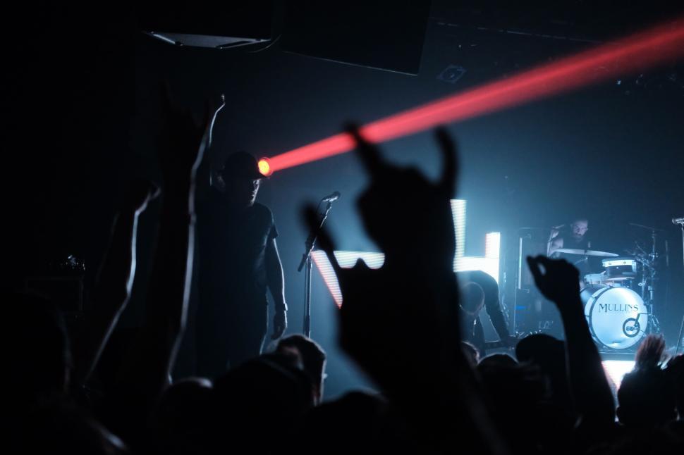 Free Image of Energetic concert with a laser and hands in the air. 