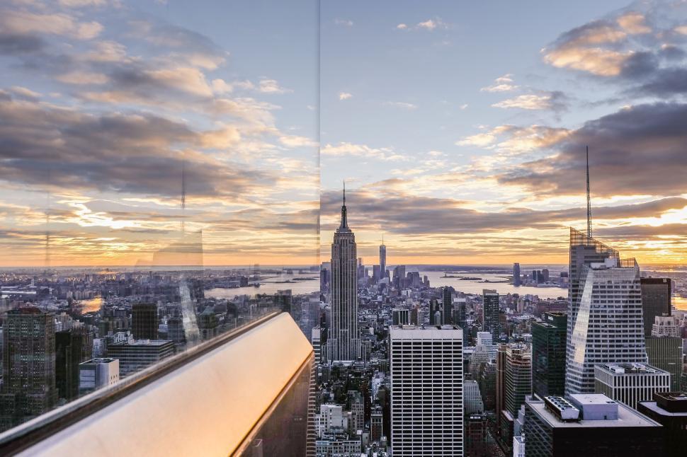 Free Image of City skyline at sunset with notable Empire State Building view. 