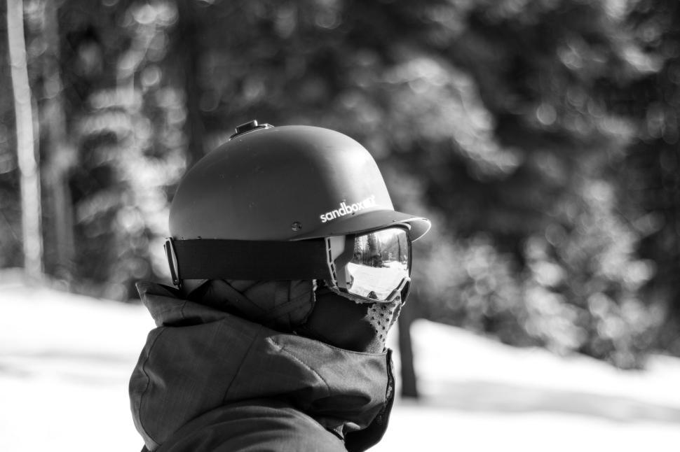 Free Image of Monochrome image of a snowboarder wearing helmet and goggles. 