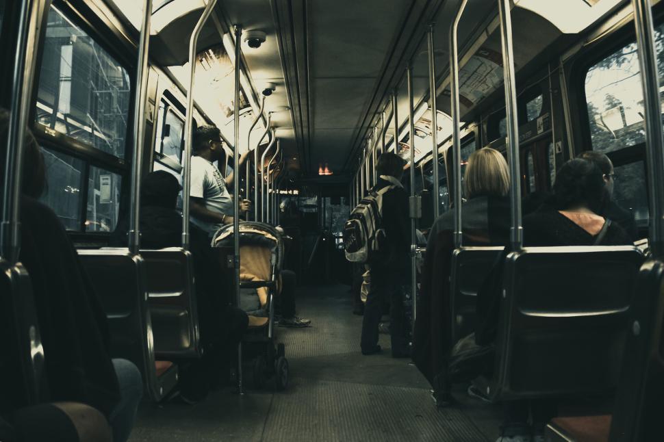Free Image of Interior of a bus with passengers seated during daytime commute 