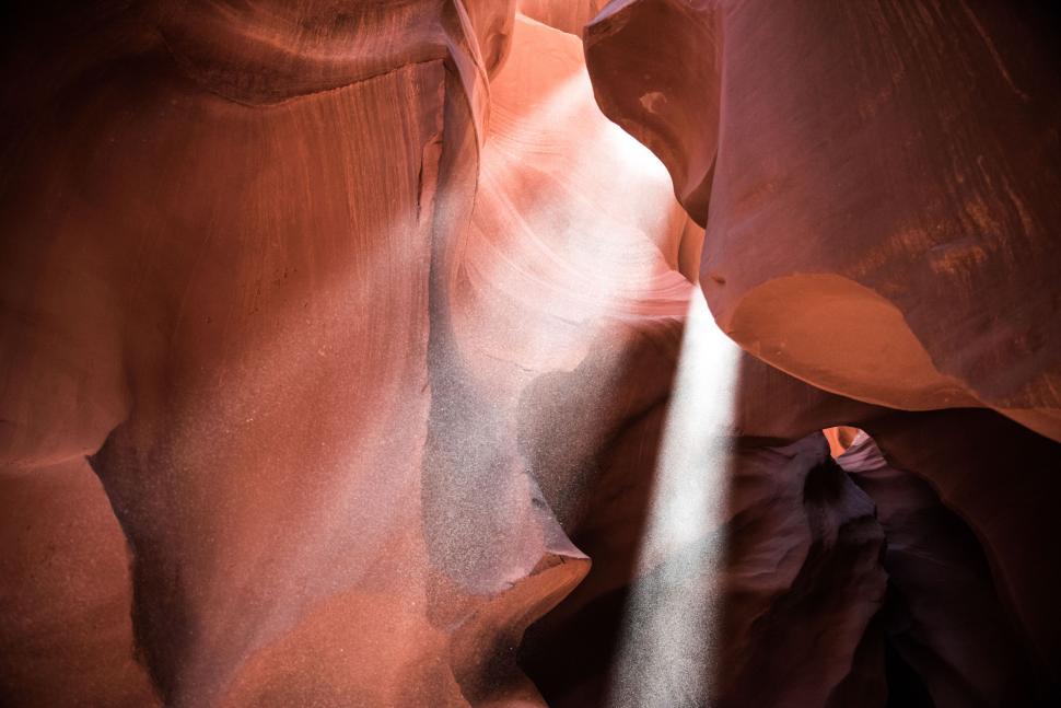 Free Image of Sunlight penetrating sandstone walls in a desert slot canyon. 