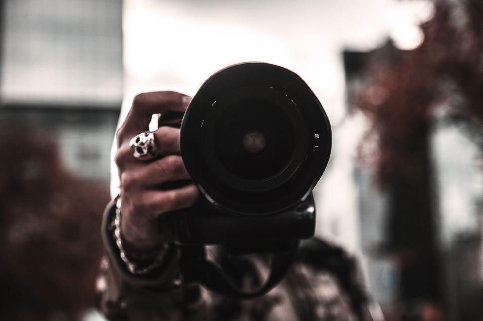 Free Image of Close-up of a camera lens being held up towards the viewer. 
