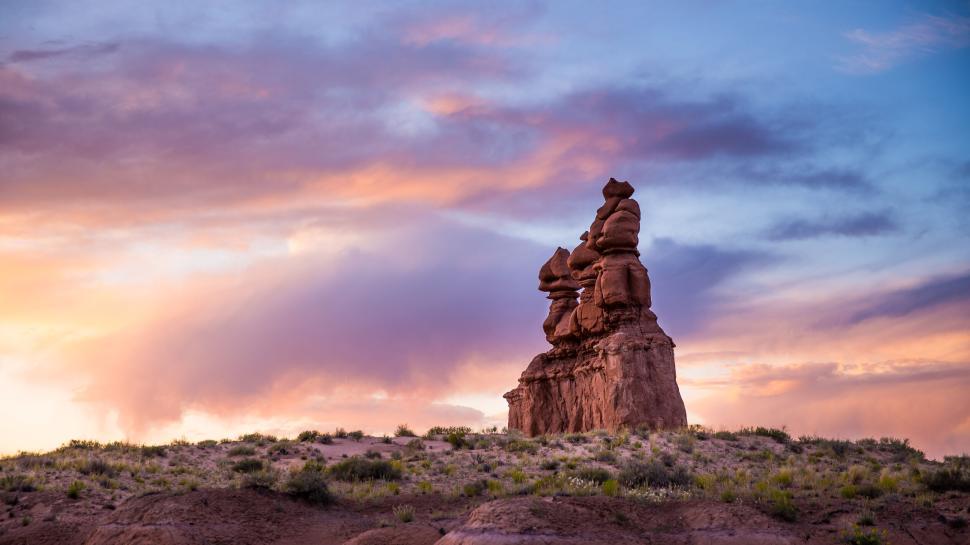 Free Image of Scenic rock formations under vibrant sunset in desert landscape 