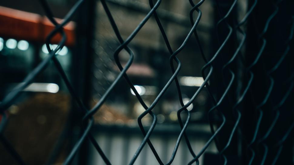 Free Image of Close-up of metal wire fence with a blurred background at daytime. 