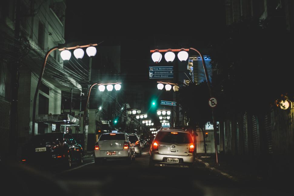 Free Image of Night city street with car traffic and illuminated streetlights. 