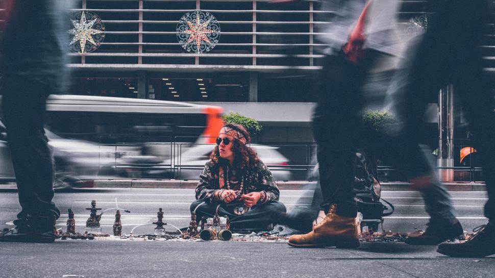 Free Image of Sidewalk Vendor with Handcrafted Goods Surrounded by Passersby 