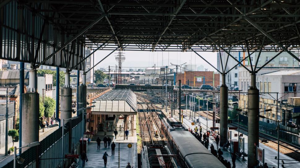 Free Image of Crowded train station with different people and departing trains. 