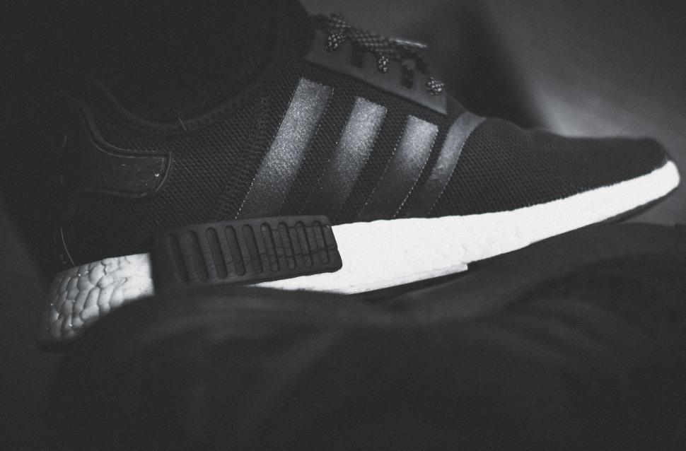 Free Image of Close-up of sleek black sneaker with white sole in monochrome. 