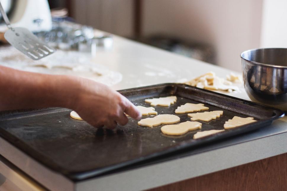 Free Image of Baking cookies with various shapes on a baking tray in kitchen. 