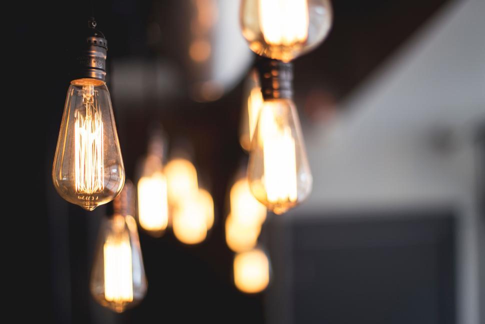 Free Image of Close-up of multiple vintage-style hanging light bulbs glowing. 