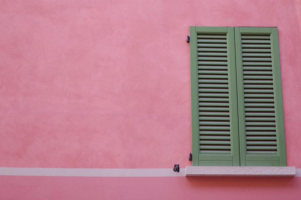 Free Image of Green shutters on a vibrant pink wall, displaying contrast visually 