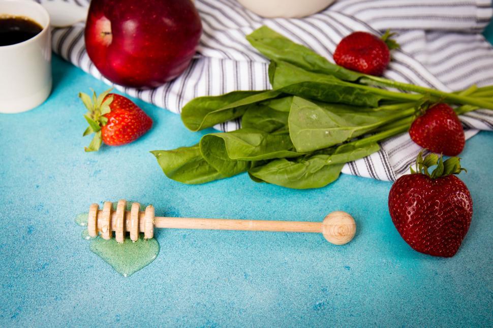 Free Image of A composition of strawberries, honey, spinach, apple, and coffee white 