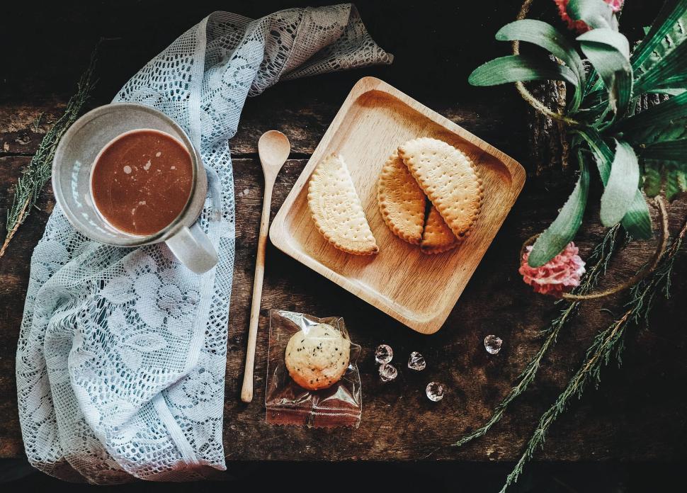 Free Image of Artistic arrangement of cookies, hot chocolate, and lace on a table. 