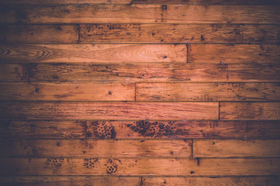 Free Image of Texture of a worn wooden floor with visible patterns and scratches. 
