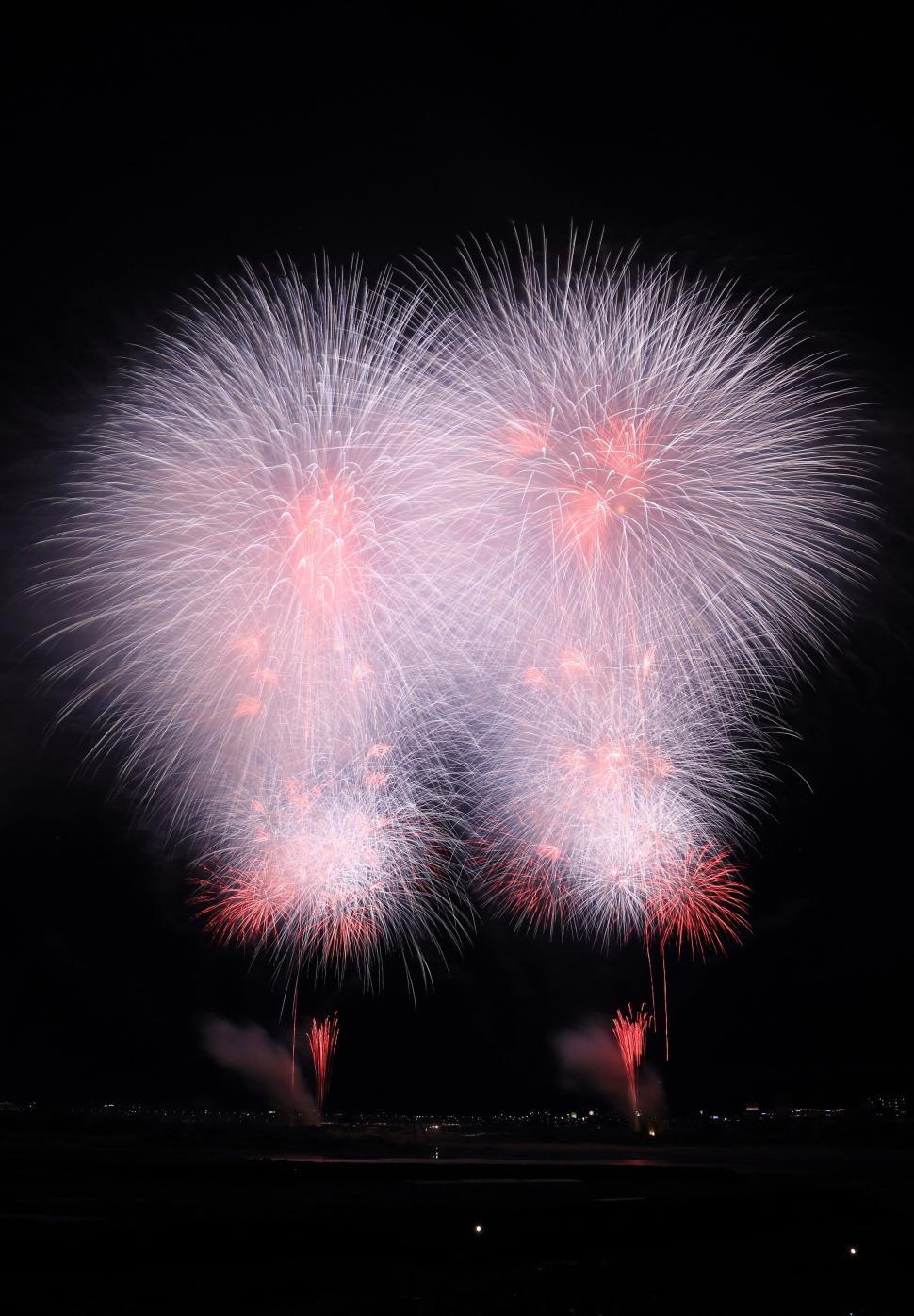 Free Image of Four large fireworks exploding with vibrant colors at night. 