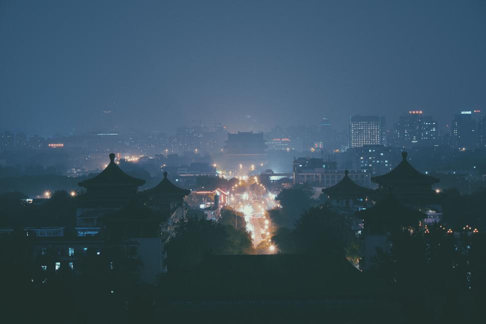 Free Image of City streets illuminated under the night sky with distant skyline 