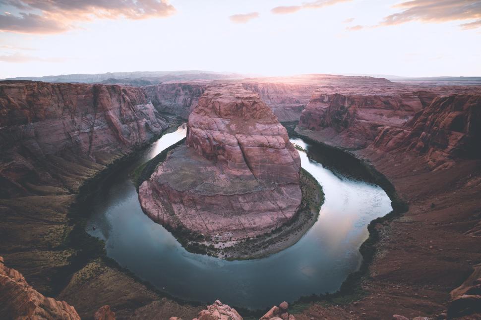 Free Image of Panoramic view of winding river carving through vast rocky canyon. 