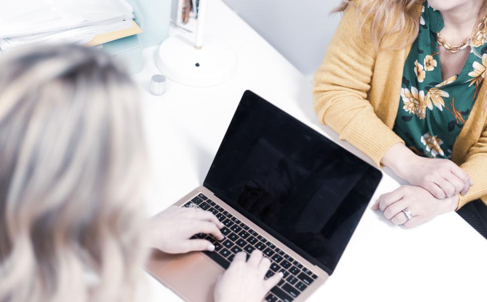 Free Image of Women collaborating with laptop at bright office table 