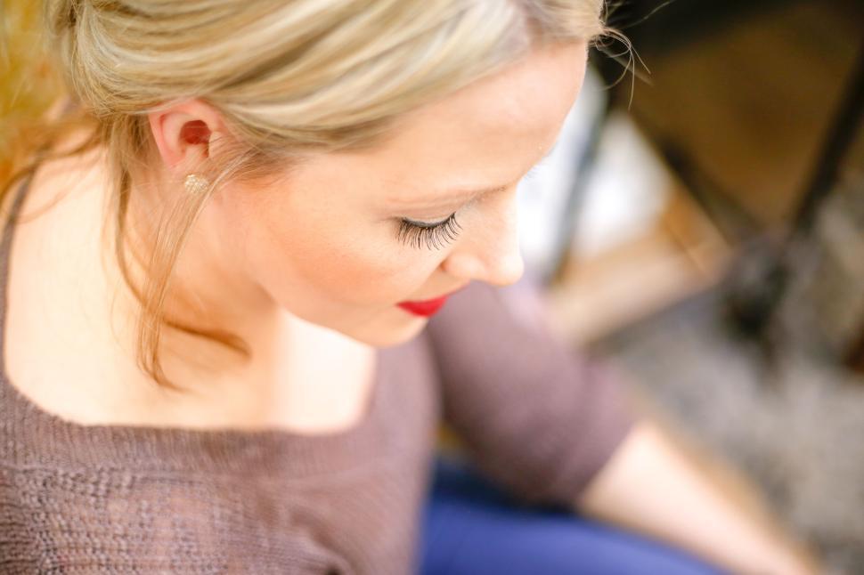 Free Image of Close-up of woman sitting and relaxing with blurred background 