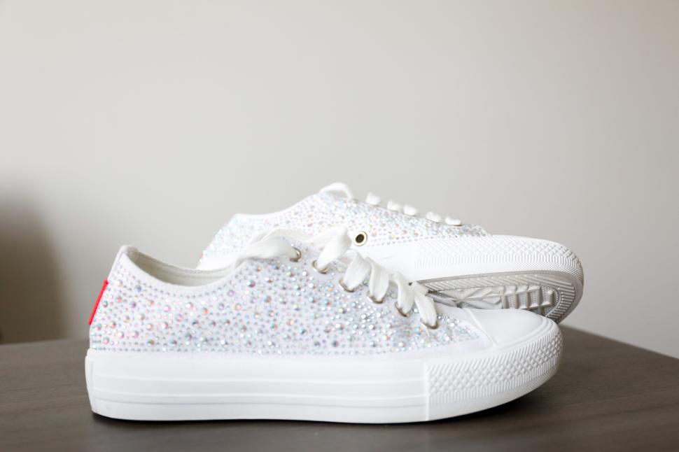 Free Image of White sparkling sneakers with a shiny silver sequin embellishment 