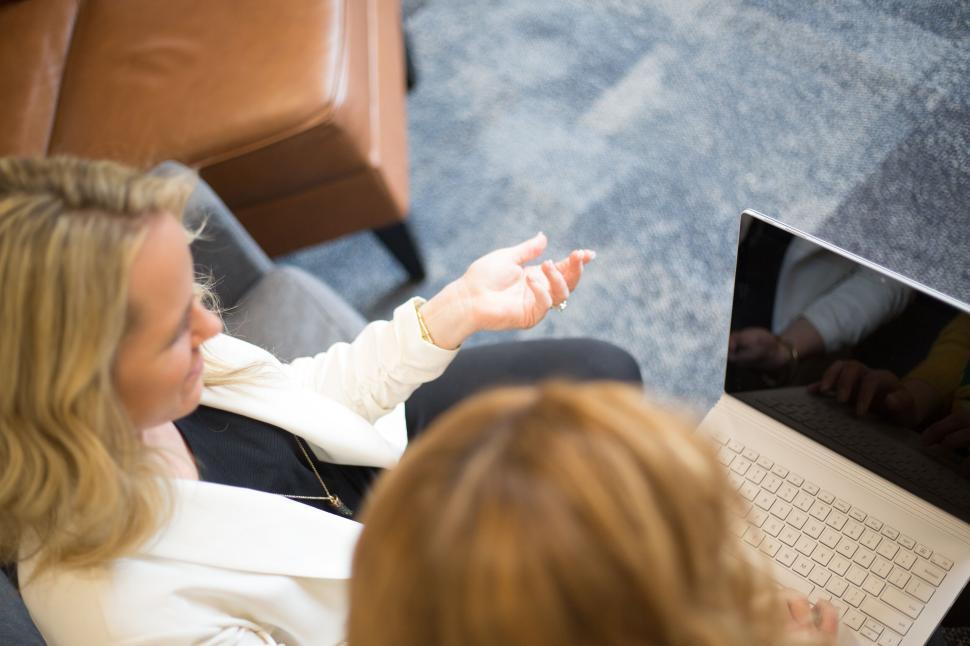 Free Image of Two women having a professional meeting with a laptop open. 