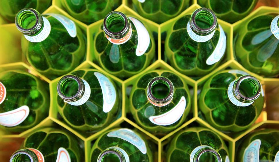 Free Image of Top view of green glass bottles arranged in a hexagonal pattern. 