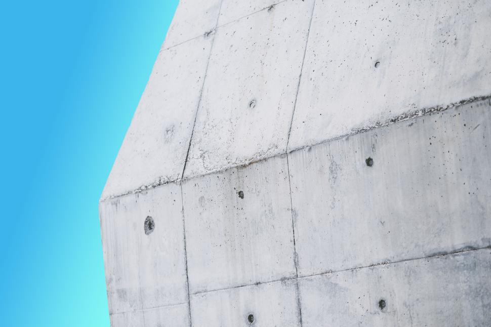 Free Image of Abstract concrete wall design against clear blue sky background. 