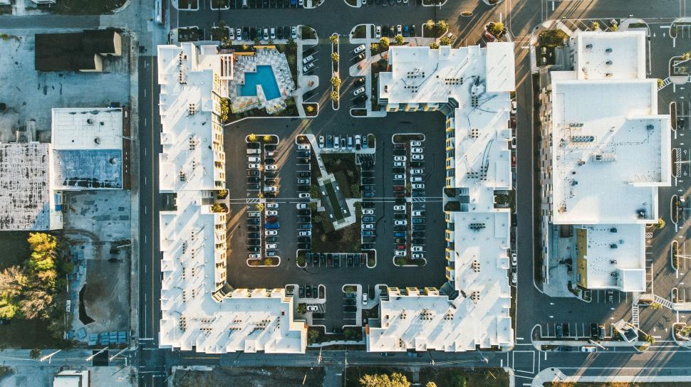 Free Image of Symmetrical buildings with central parking lot seen from above 