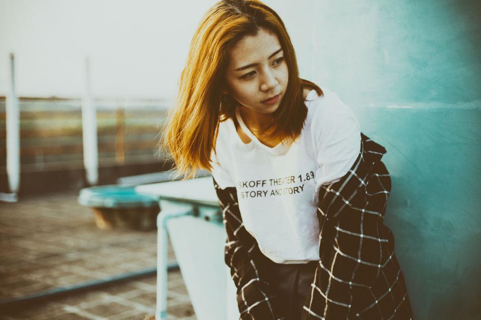 Free Image of Candid portrait of a woman in casual attire outdoors 