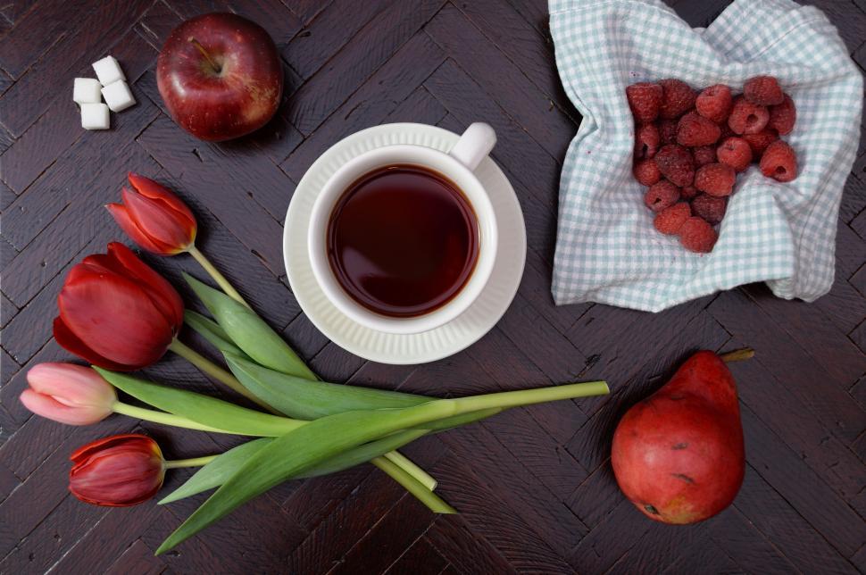 Free Image of Culinary still life with tea, tulips, raspberries, apples, and pears 