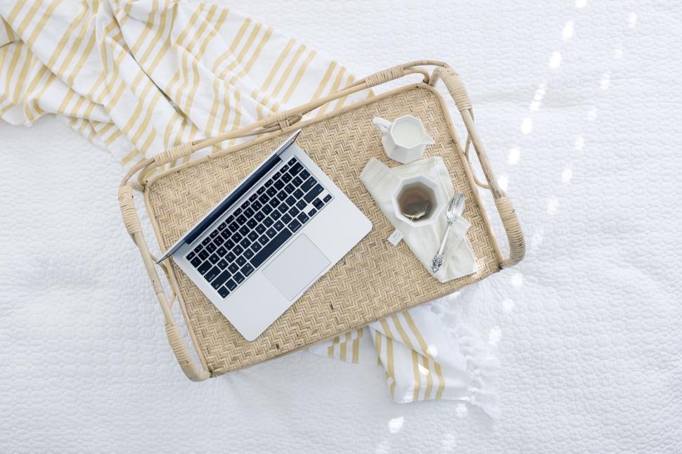 wicker-tray-on-bed-holding-laptop-and-tea-with-white-linens.jpg
