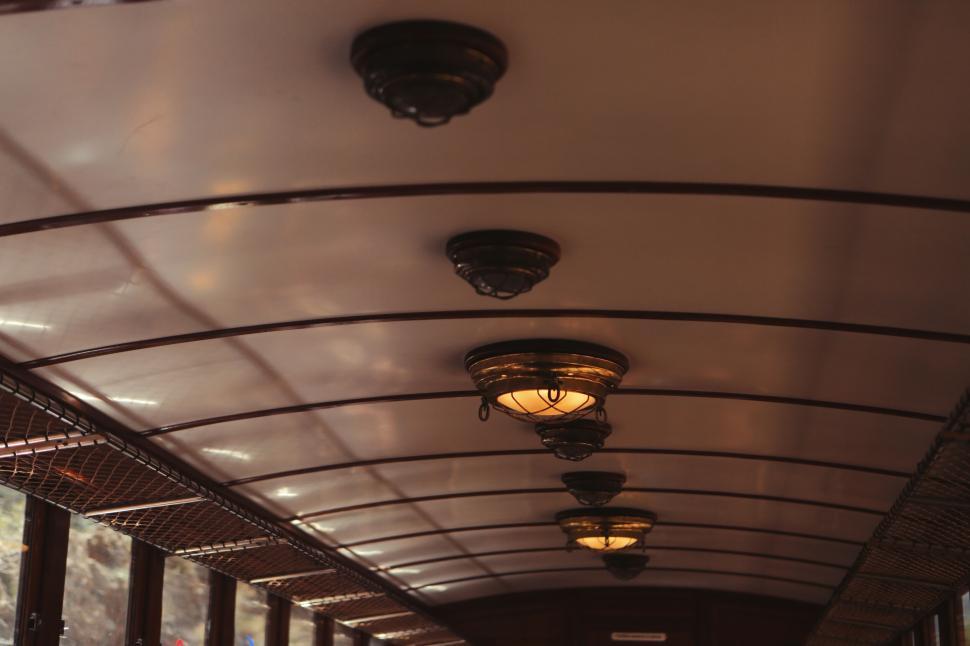 Free Image of Vintage interior of old tram featuring light fixtures and woodwork 