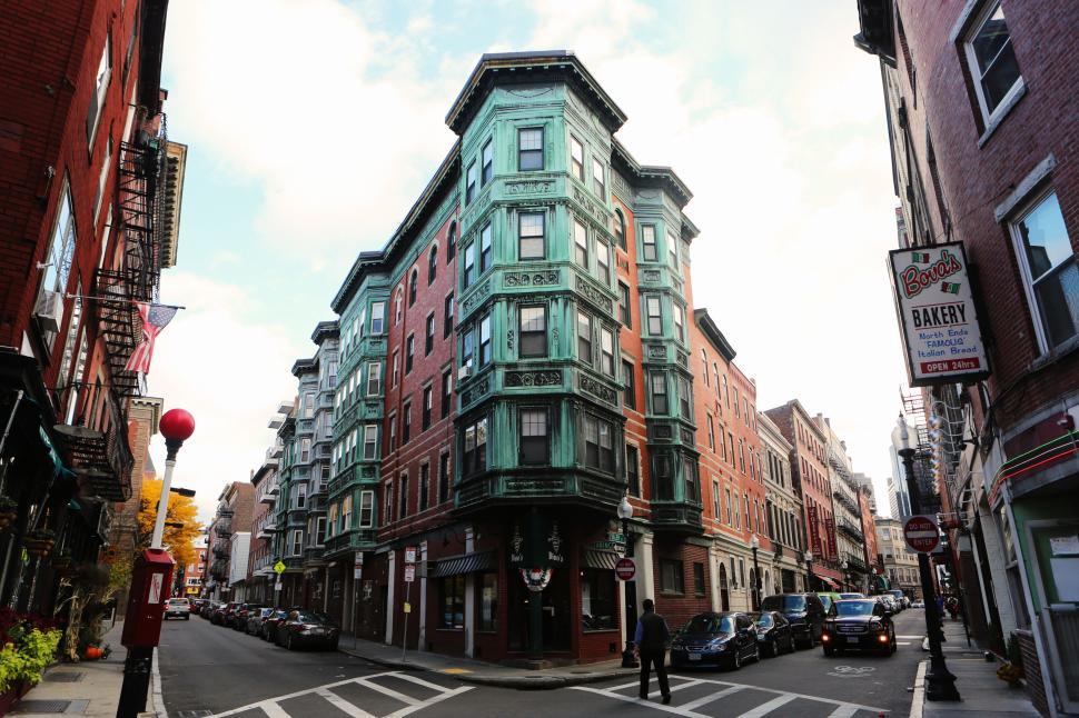 Free Image of Angled view of a historical building with green facade on a city corner 