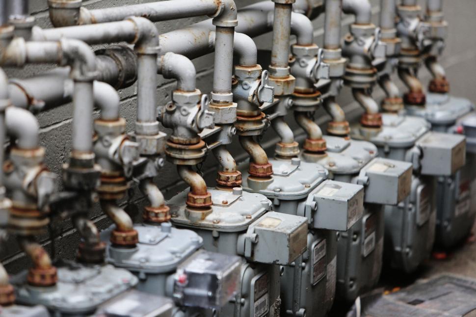 Free Image of Row of industrial gas meters with intricate piping network. 