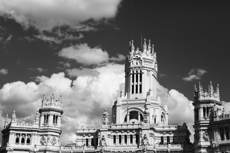 Free Image of Historic building with ornate towers and dramatic clouds in sky 