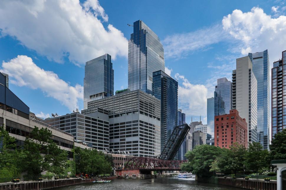 Free Image of Chicago skyline with elevated bridge and river on a clear day. 
