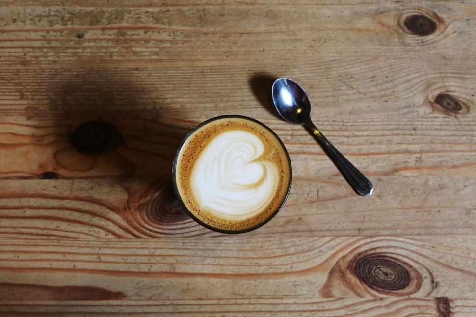 Free Image of Artistic presentation of a cup of coffee with heart-shaped foam. 
