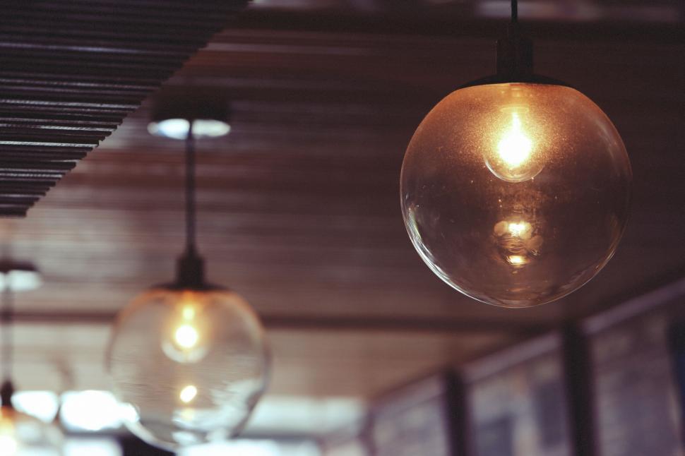 Free Image of Modern hanging lights in a cozy wooden interior setting 