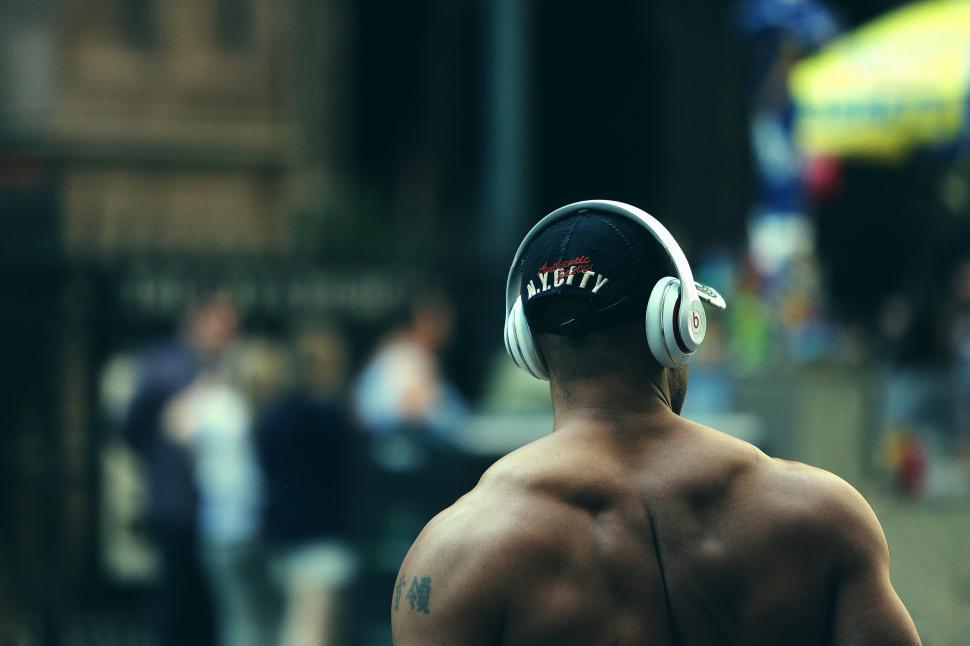 Free Image of Back view of a person with headphones in urban environment 