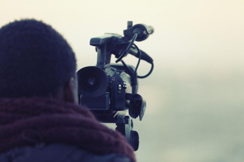 Free Image of Videographer capturing a scenic view with professional camera 