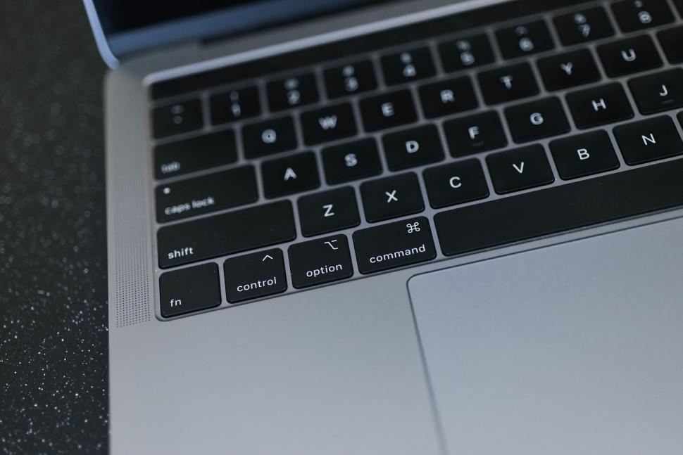 Free Image of Close up of a laptop keyboard with black keys and minimal design 