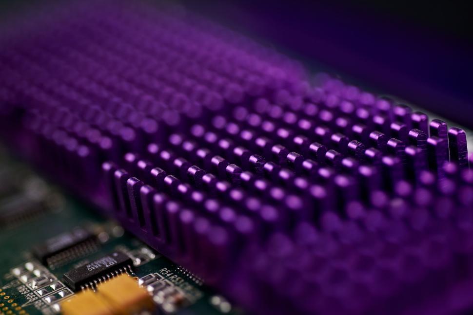 Free Image of Purple heat sink on a circuit board focusing on detail and texture. 