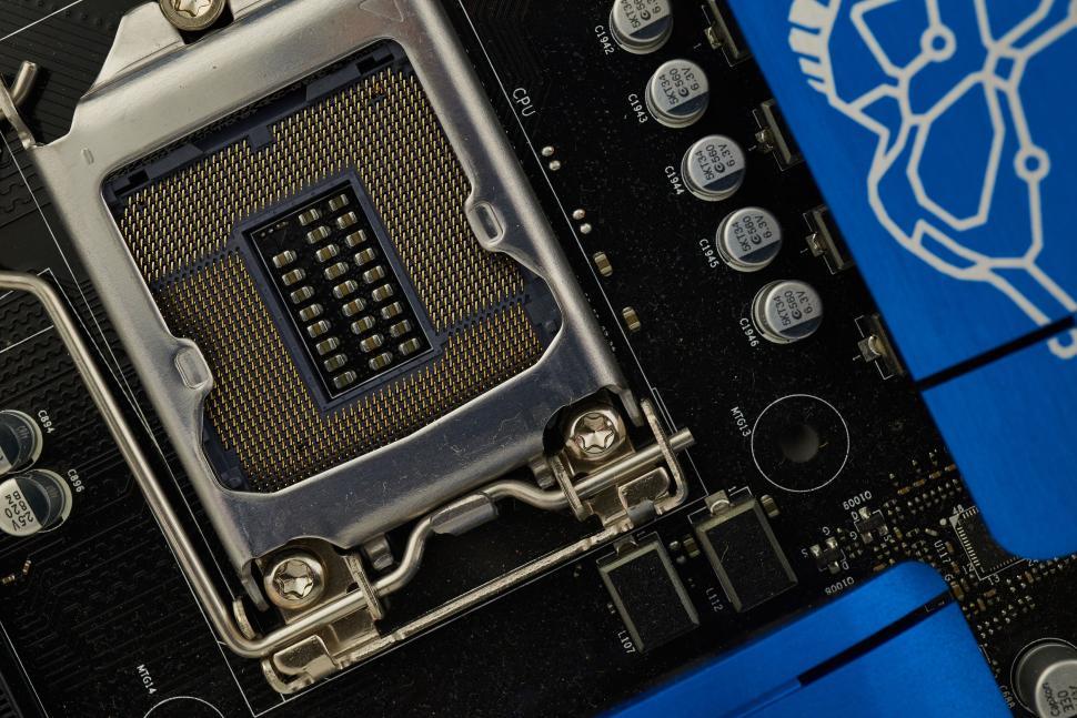 Free Image of Computer motherboard close-up with CPU socket and blue heatsink 