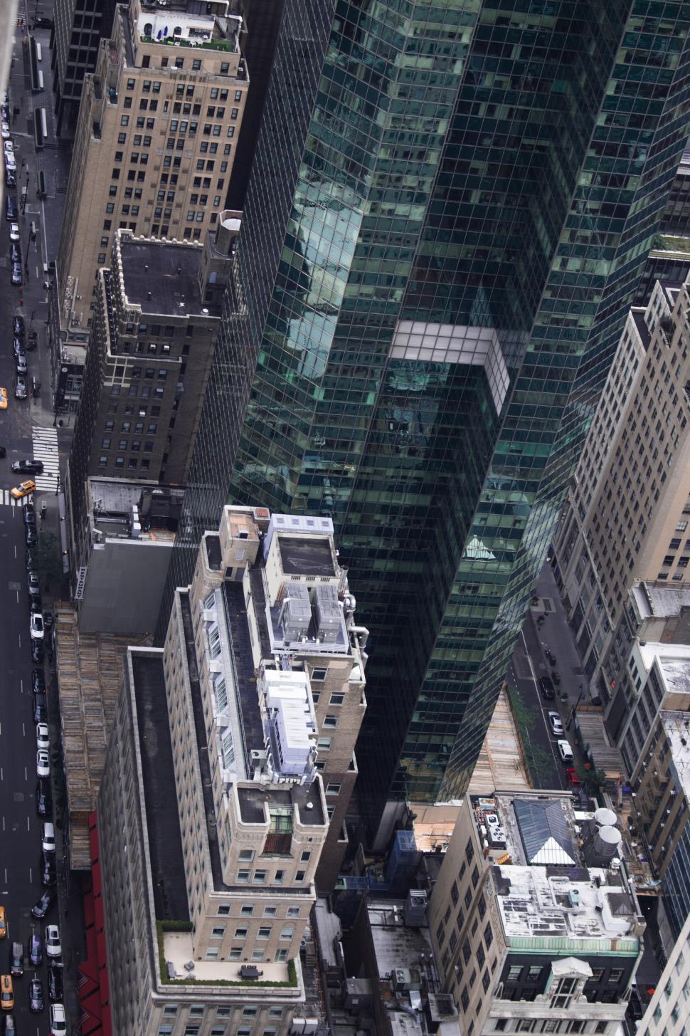 Free Image of Aerial view of skyscraper dominating urban city street below 