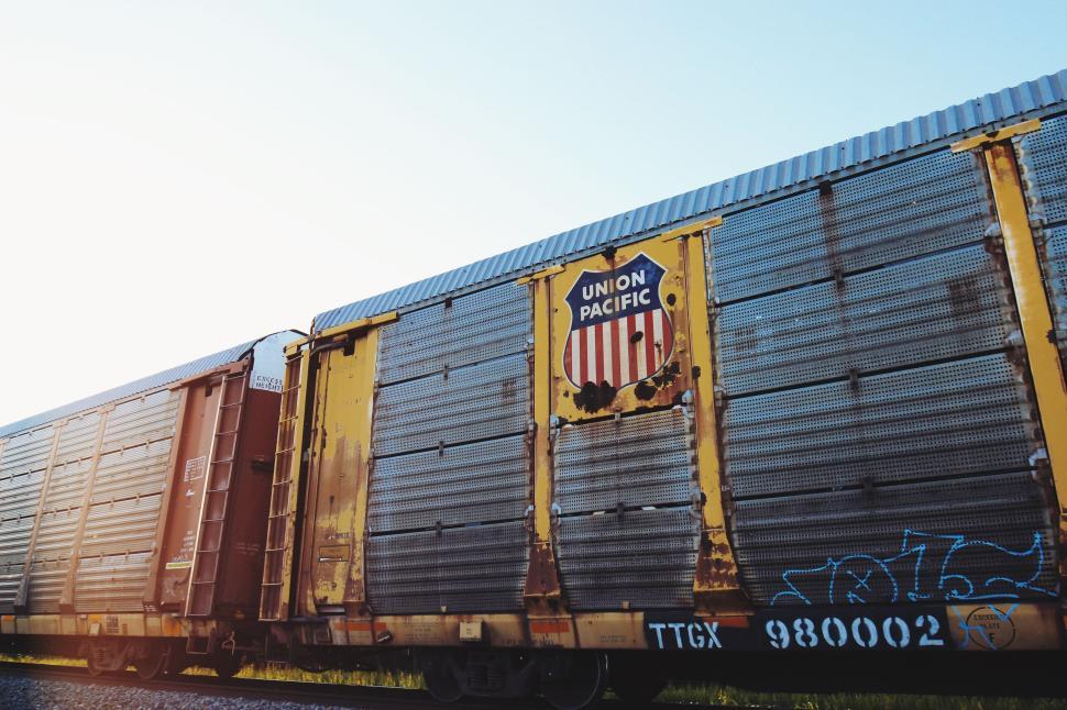 Free Image of Union Pacific freight train car with graffiti on a sunny day 