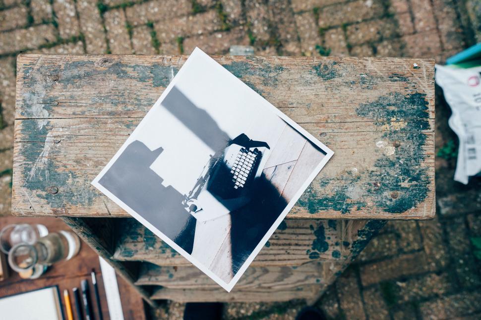 vintage-photograph-of-a-typewriter-resting-on-a-weathered-wooden-stool.jpg