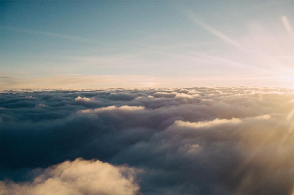 Free Image of Sunrise sunlight over cloudy horizon with sunrays and sky view 