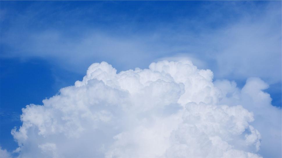 Free Image of Massive fluffy white clouds against a pure blue sky, no objects 